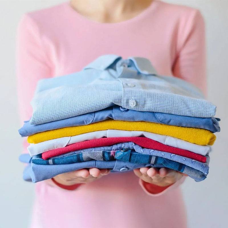 Laundry service Dubai with neatly folded garments.